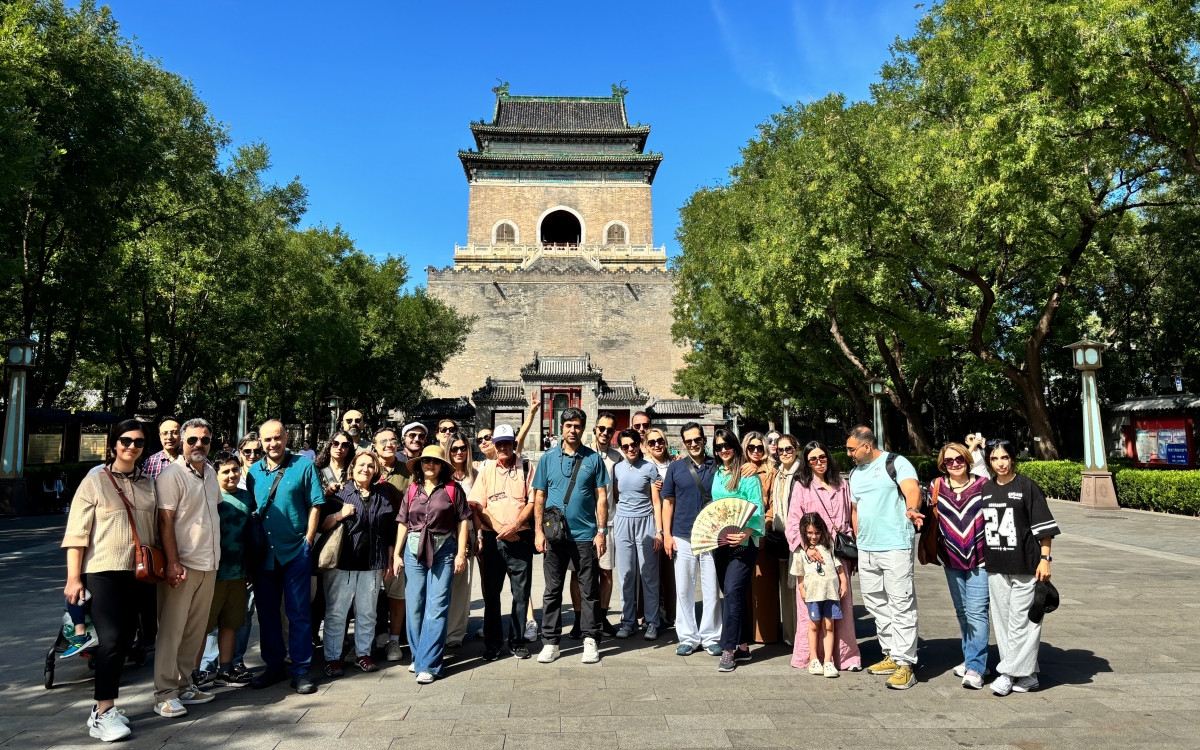 Guests posing in front of the Bell Tower in Beijing